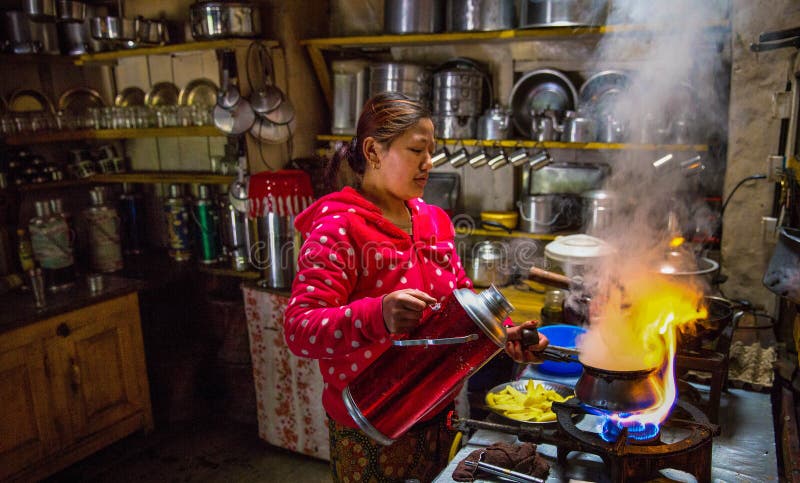 Nepali woman is cooking in a traditional tea house kitchen Annapurna Circuit, Nepal. Nepali woman is cooking in a traditional tea house kitchen Annapurna Circuit, Nepal