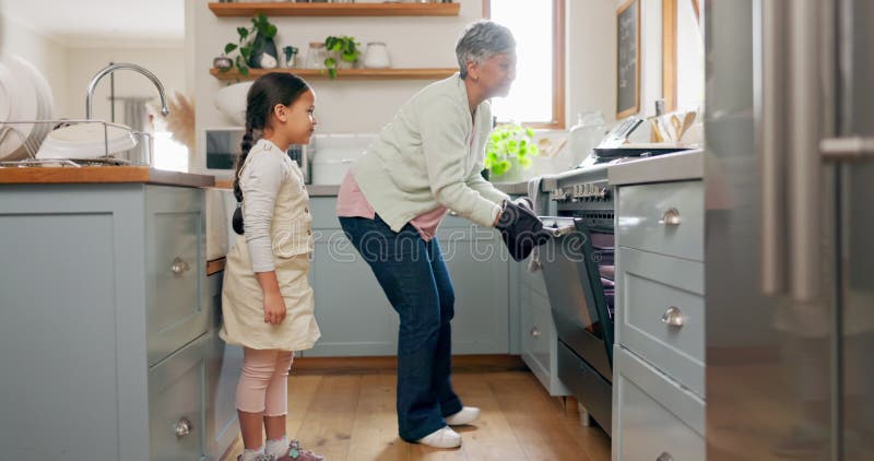 Kitchen, teaching and grandmother cooking with child learning to prepare dinner, supper or lunch in a home. Grandchild