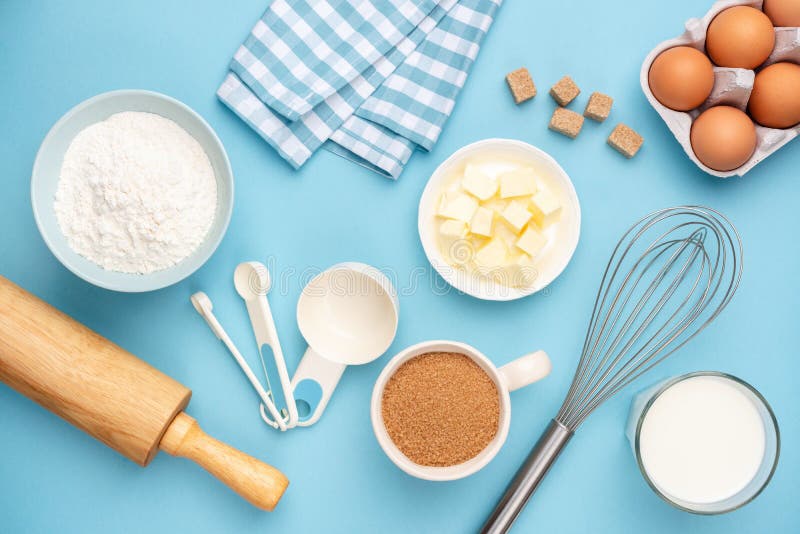 Kitchen utensils and baking ingredients on blue background