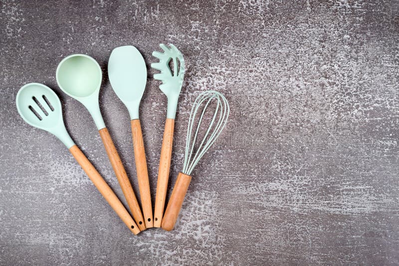Kitchen utensils background with copyspace, home kitchen decor concept,  black kitchen tools, rubber accessories in container.Restaurant, cooking,  culinary, kitchen theme. Silicone spatulas and brushes Stock Photo