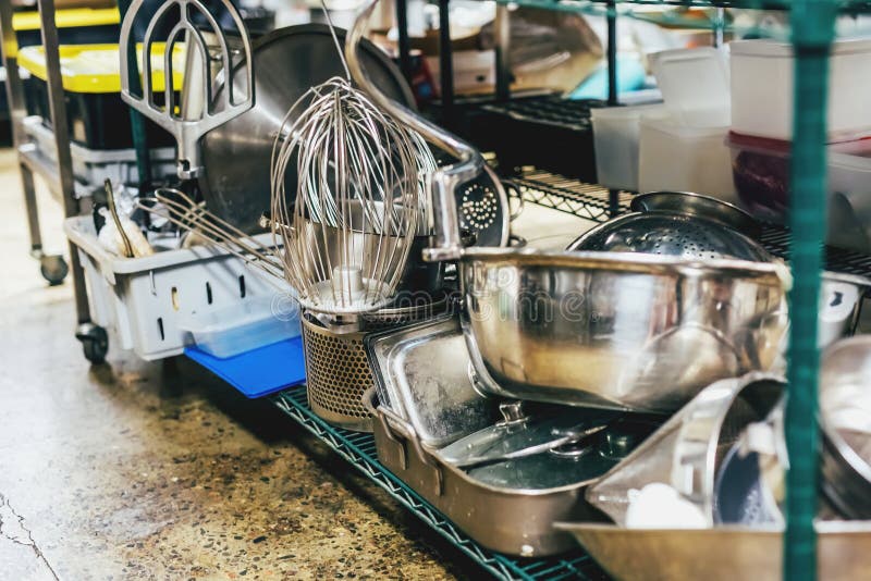Kitchen Utensils on Shelves in an Industrial Kitchen Stock Photo