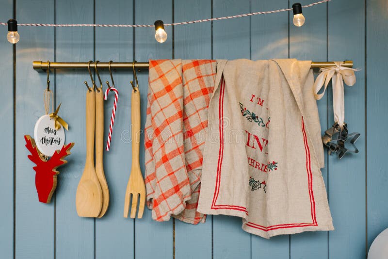 Kitchen utensils: wooden spoons and spatulas, linen towels on the holder in the kitchen in blue tones in Scandinavian style, decor stock image Kitchen utensils: wooden spoons and spatulas, linen towels on the holder in the kitchen in blue tones in Scandinavian style, decor stock image