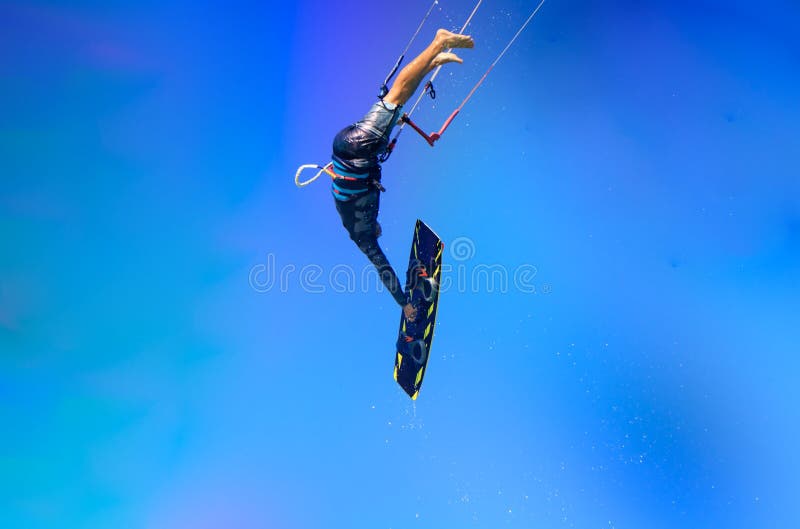 Kite sportsman jumping with splash of water, crystal sky, kiteboarding water sports, active life style. Kiteboarding big air frees stock photos Kite sportsman jumping with splash of water, crystal sky, kiteboarding water sports, active life style. Kiteboarding big air frees stock photos