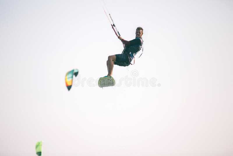 Kiteboarder Athlete Performing Kiteboarding Kitesurfing Tricks Stock