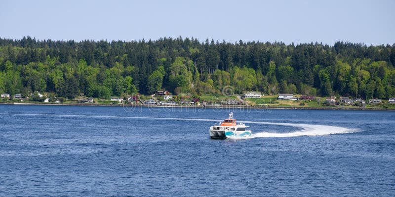 Kitsap Fast Ferry Reliance in Sinclair Inlet making wide turn in water stock photos
