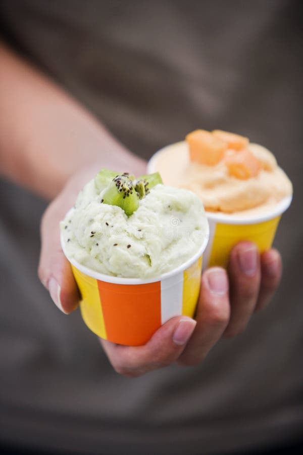 Kiwi fruit and mango ice cream held out to the viewer. Weight watchers stock images, royalty-free photos and pictures