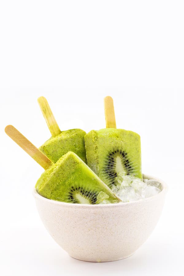 kiwi popsicle isolated on white background made with fresh fruits inside bowl with ice.