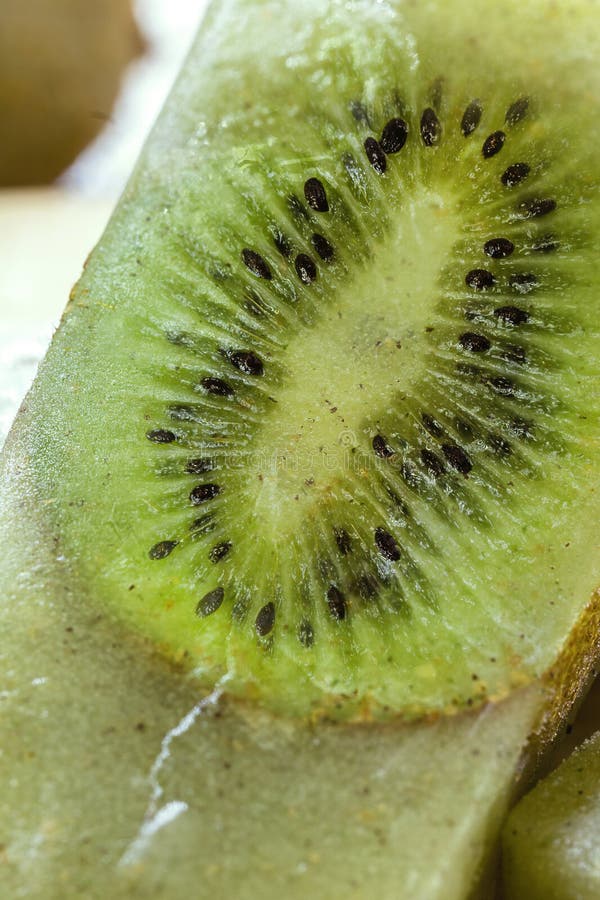 kiwi popsicle on wooden table, homemade and cold dessert, made with fresh fruits without sugar.