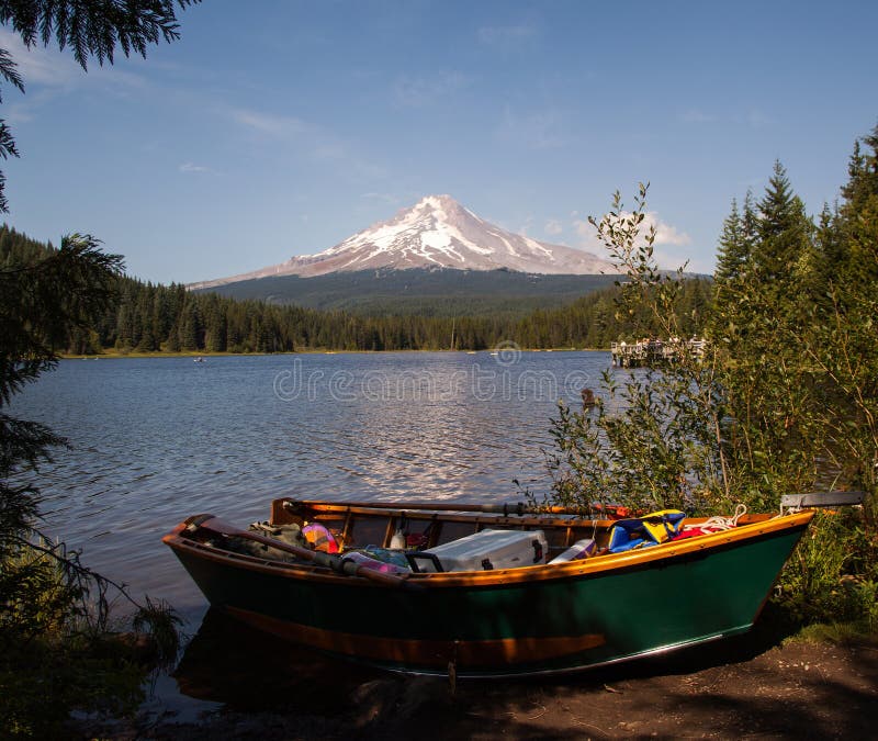 A green boat is packed and ready for a perfect day on the edge of Trillium Lake below Oregon's iconic Mt Hood. A green boat is packed and ready for a perfect day on the edge of Trillium Lake below Oregon's iconic Mt Hood.