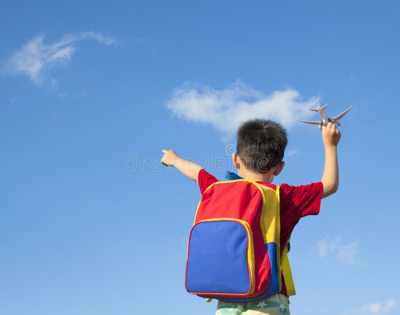 Little boy holding a airplane toy and point to sky. Little boy holding a airplane toy and point to sky