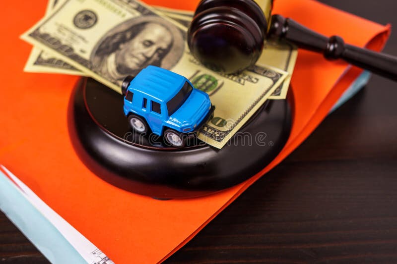 Kleiner Wagen auf dem Tisch im Gerichtssaal. gavel auf dem schreibtisch im hofsaal. Rechtsanwaltskanzlei für Straßenverkehrsunfäll stockfoto