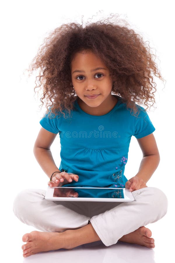 Kleines afrikanisches asiatisches Mädchen, das einen Tablette-PC verwendet lizenzfreie stockfotografie