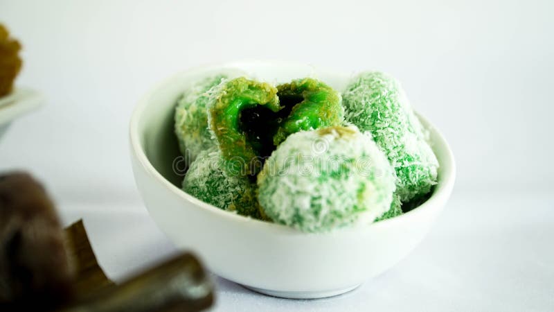 Klepon or kelepon is a Indonesian traditional cake. Made from sticky rice flour which is shaped like small balls and filled with brown sugar and then boiled in stock photo Klepon or kelepon is a Indonesian traditional cake. Made from sticky rice flour which is shaped like small balls and filled with brown sugar and then boiled in stock photo