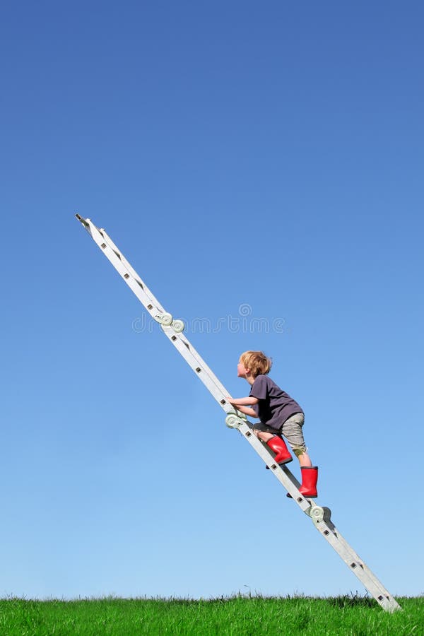 Young boy climbs a ladder on green meadow with blue sky. Young boy climbs a ladder on green meadow with blue sky