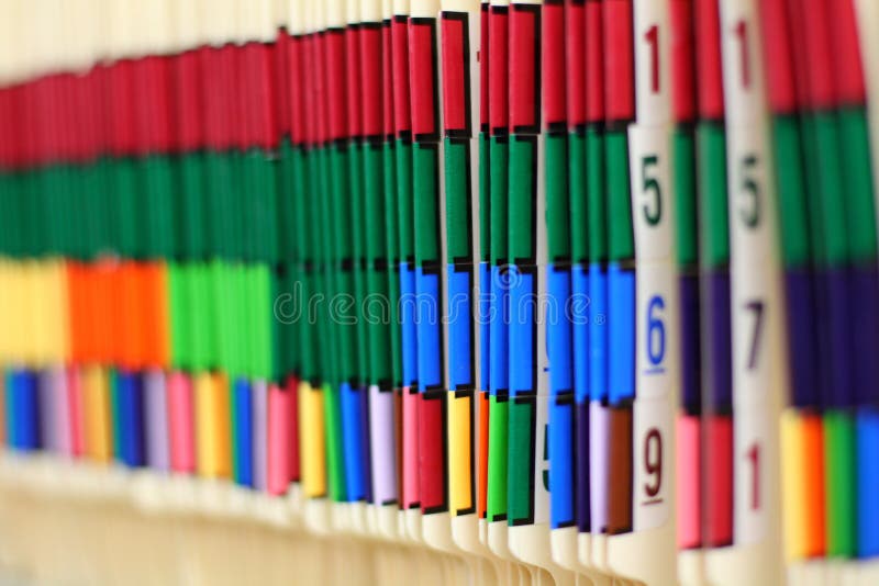 Colorful medical records line the shelf in this doctor's office. Colorful medical records line the shelf in this doctor's office.