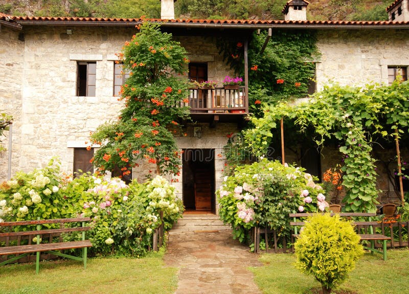 Idyllic stone rural house with pretty cottage garden. Idyllic stone rural house with pretty cottage garden.