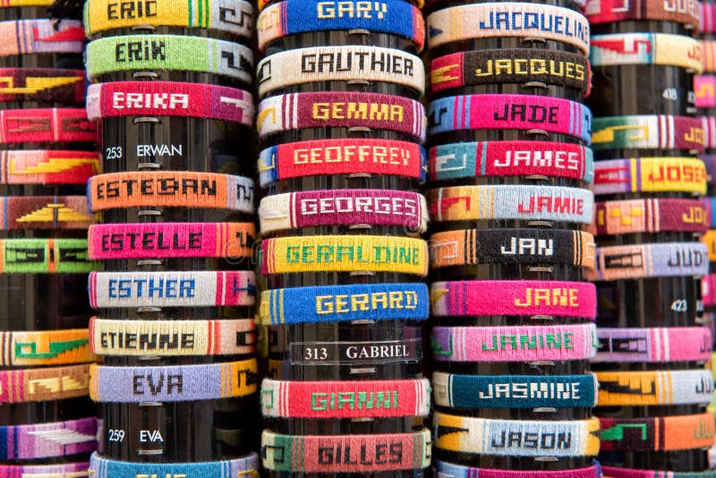 Rows of colourful bracelets with French names in close-up. Rows of colourful bracelets with French names in close-up