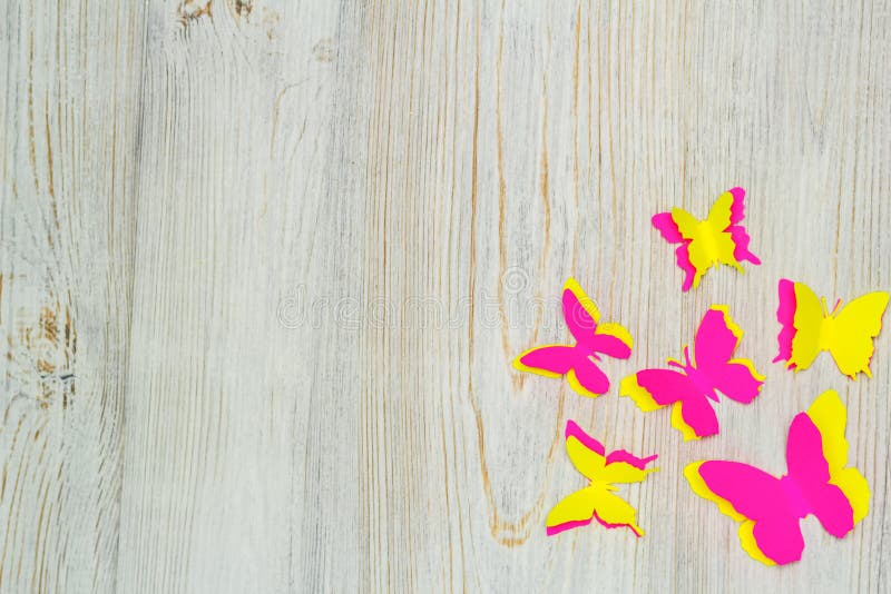 Colorful paper butterflies on wooden background. Children`s developmental activity. Application and origami. Flat lay. Colorful paper butterflies on wooden background. Children`s developmental activity. Application and origami. Flat lay