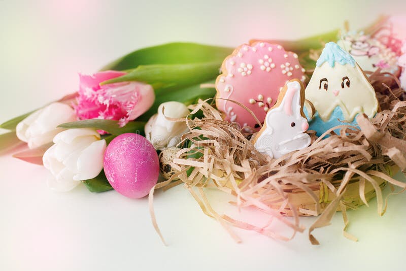 Kleurrijke Pasen-koekjes met het berijpen van suikerglazuurdecor, geschilderde kleurrijke eieren en tulpen op lichte lijst Het co royalty-vrije stock afbeelding Kleurrijke Pasen-koekjes met het berijpen van suikerglazuurdecor, geschilderde kleurrijke eieren en tulpen op lichte lijst Het co royalty-vrije stock afbeelding