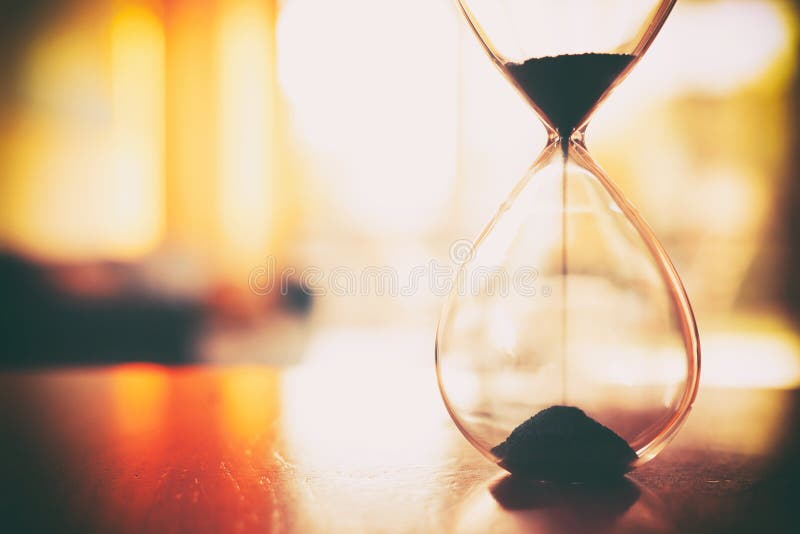 Klocka för årgångsglas över bord royaltyfria foton
