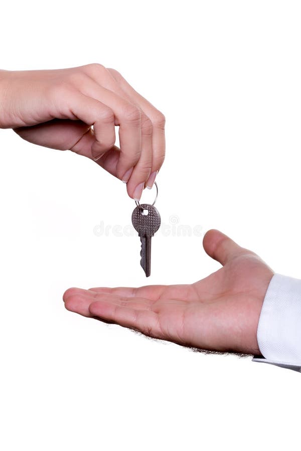 The female hand transfers keys in a mans hand. The female hand transfers keys in a mans hand