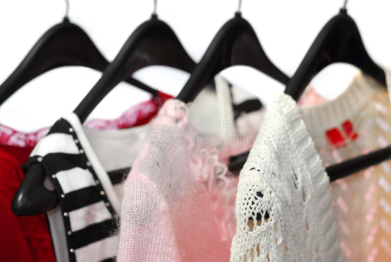 Women's clothing on a rack, white background. Women's clothing on a rack, white background