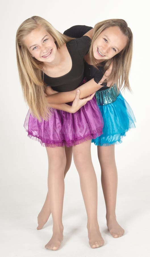 Teen girl modeling a short skirt in studio against a white background. Teen girl modeling a short skirt in studio against a white background.