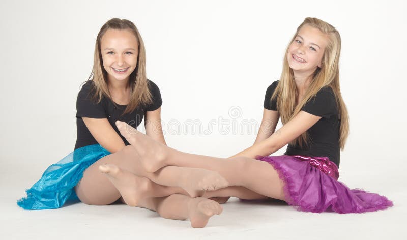 Teen girl modeling a short skirt in studio against a white background. Teen girl modeling a short skirt in studio against a white background.