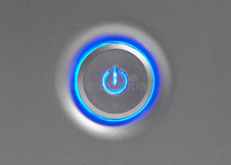 Blue glowing power button closeup on computer. Blue glowing power button closeup on computer