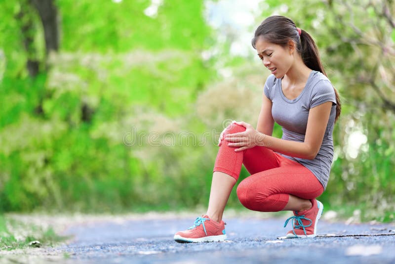 Knee Injury - sports running knee injuries on woman in pain. Female runner with pain from sprain knee. Close up of legs, muscle and knee outdoors. Knee Injury - sports running knee injuries on woman in pain. Female runner with pain from sprain knee. Close up of legs, muscle and knee outdoors.