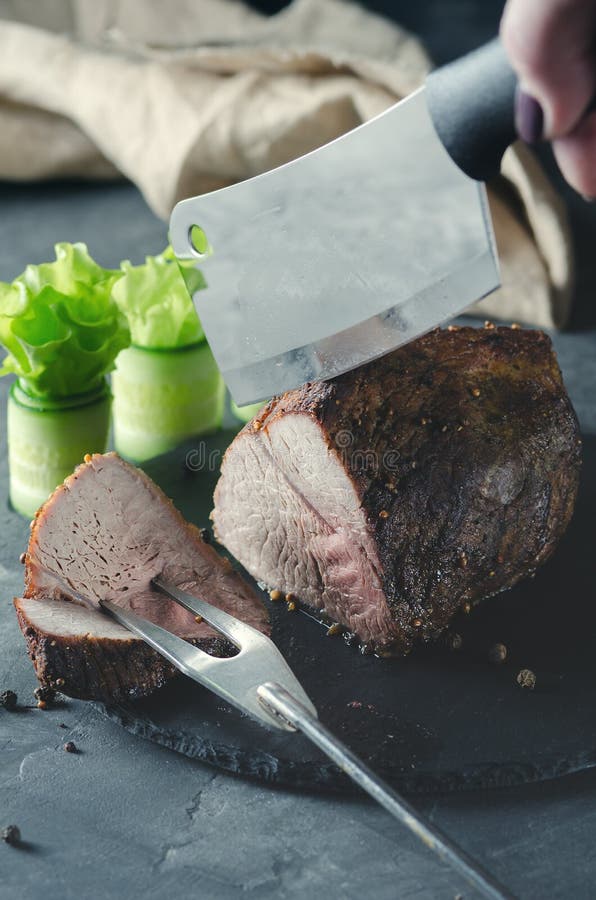 The Knife Cuts a Piece of Baked Pork. Stock Image Image of dish