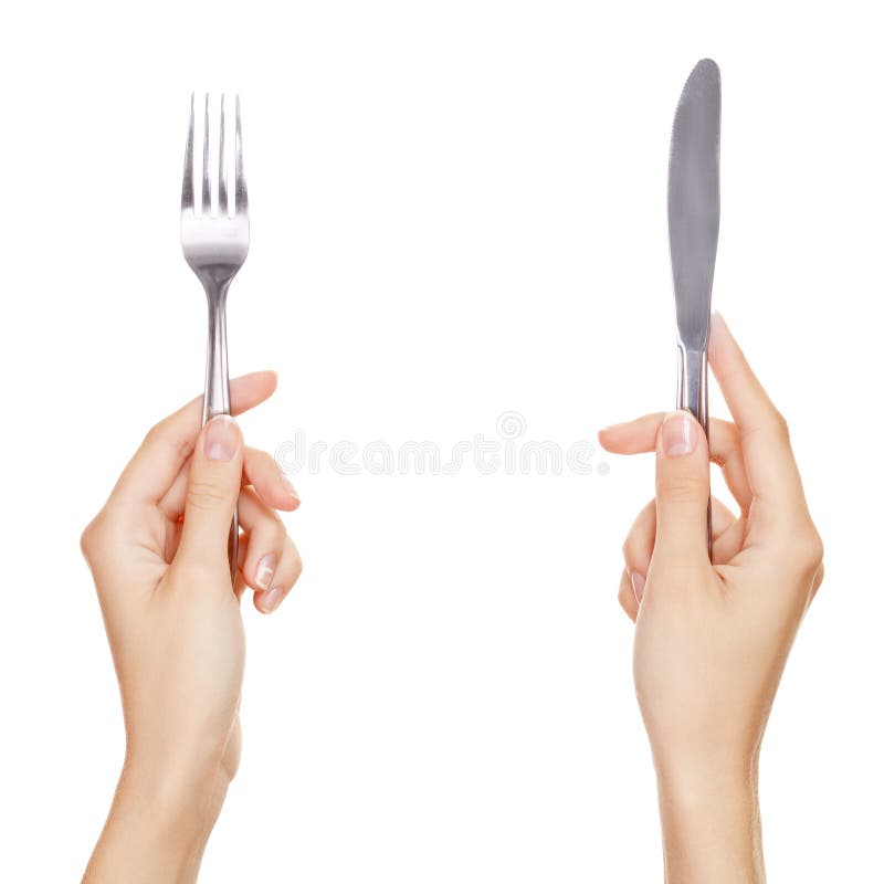 A knife and fork being held by womans hands. stock photos