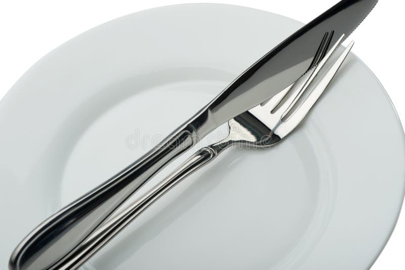 Knife and fork on a plate stock image. Image of diner 11120395