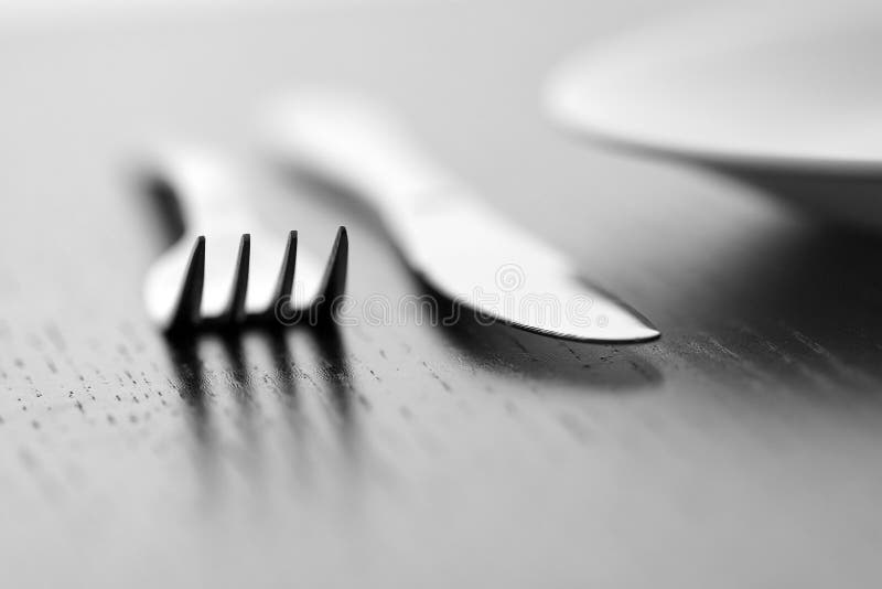 Knife, fork and plate stock image