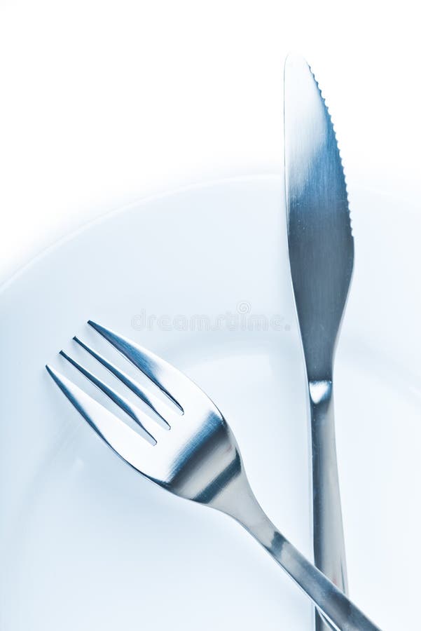 Knife and fork on plate stock photo. Image of arranging 29890490