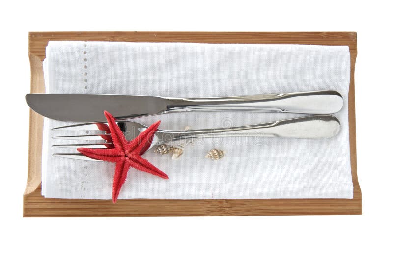 Knife and fork with seashells and starfish