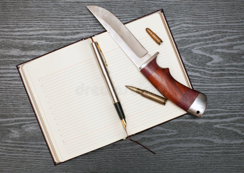 Knife and notebook stock photo