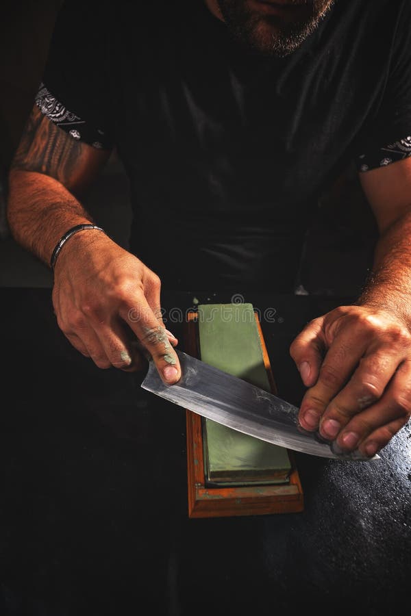 Knife Sharpening, Knife on Isolated White Background with Abrasive