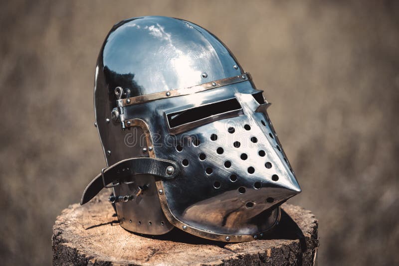 Knight, a brilliant helmet standing on a wooden stump royalty free stock image Knight, a brilliant helmet standing on a wooden stump royalty free stock image