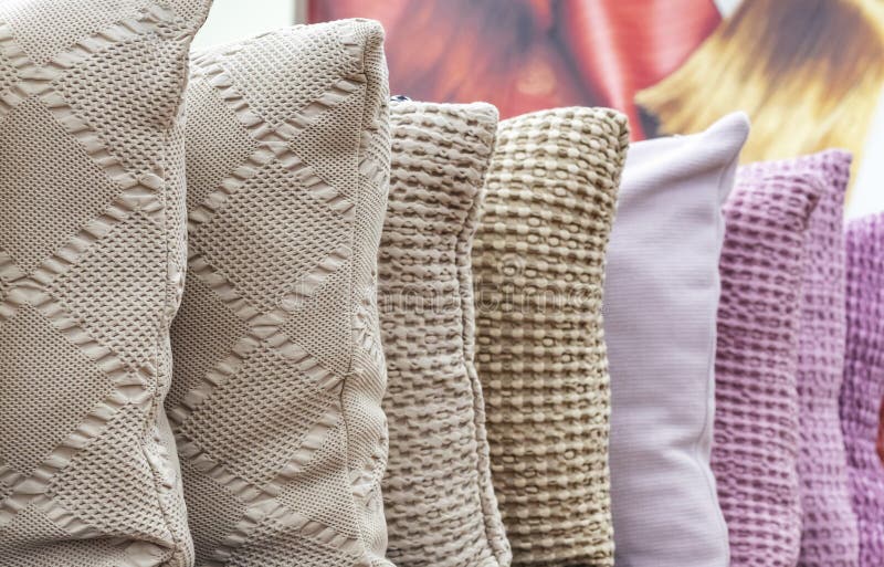 Knitted decorative pillows in different colors on the shop counter stock image Knitted decorative pillows in different colors on the shop counter stock image