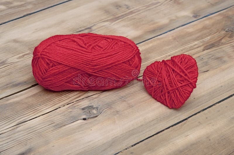 Knitted heart and red of yarn