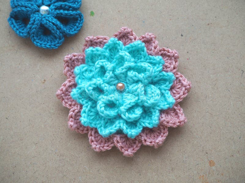 Knitting flower, crochet work on wood background