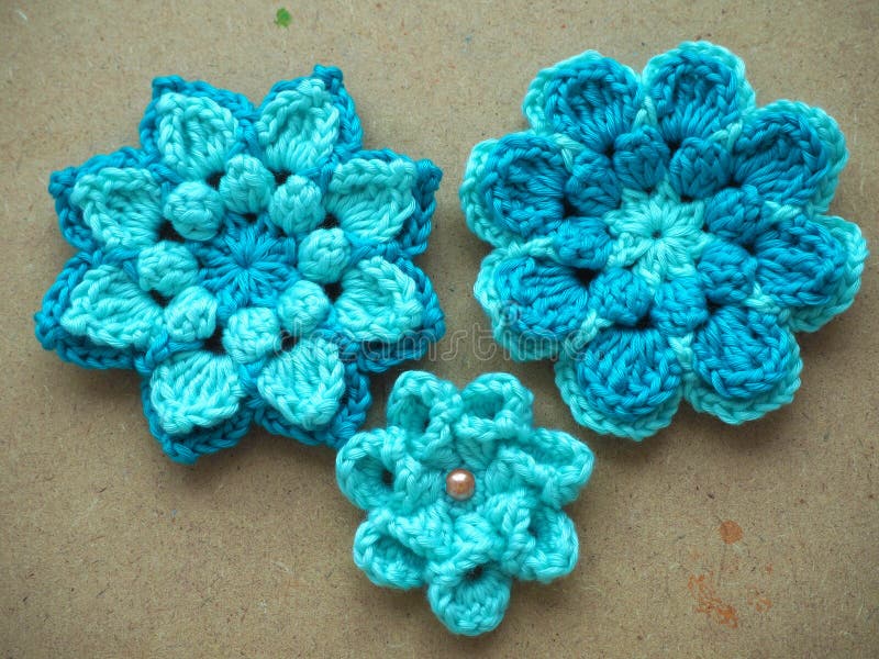 Knitting flower, crochet work on wood background