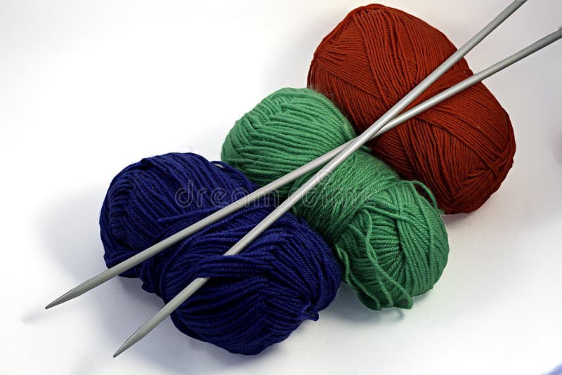Knitting needles and balls: red, green and blue