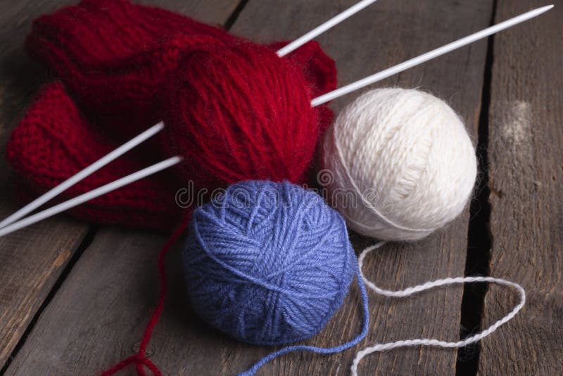 Knitting Threads and Knitting Needles on a Wooden Table Stock Photo
