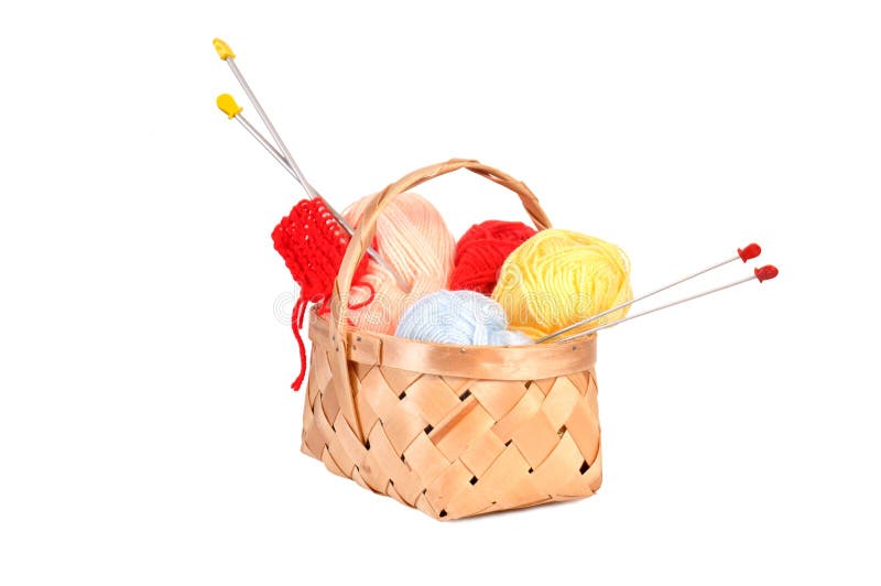 Wooden basket with woolly thread and spoke for knitting. Wooden basket with woolly thread and spoke for knitting