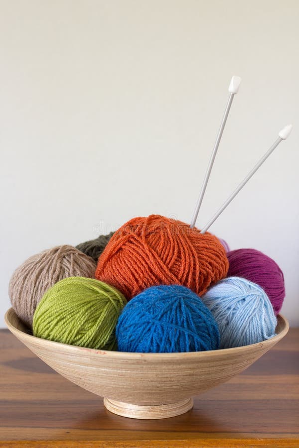 Balls of yarn in basket with knitting needles. Balls of yarn in basket with knitting needles