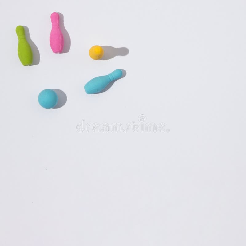Knocked Down Bowling Pins on a White Background with Copy Space