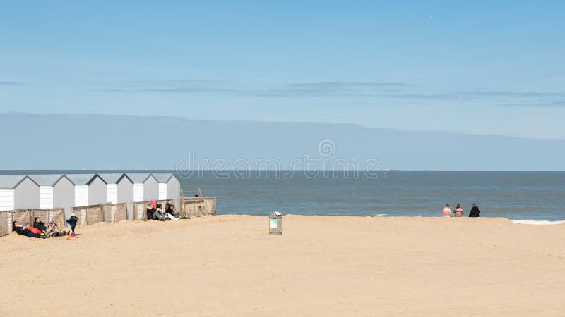 Knokke Heist, Flemish Region - Belgium - White beach cabins in a row at the sand beach during low season