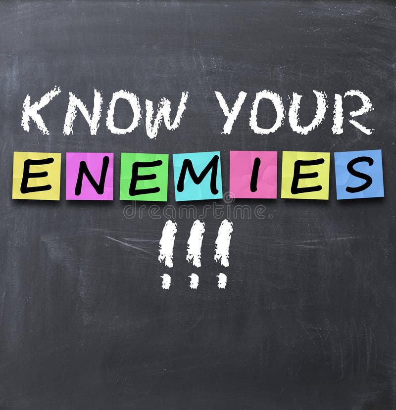 Know your enemies text on a blackboard with chalk and stickers